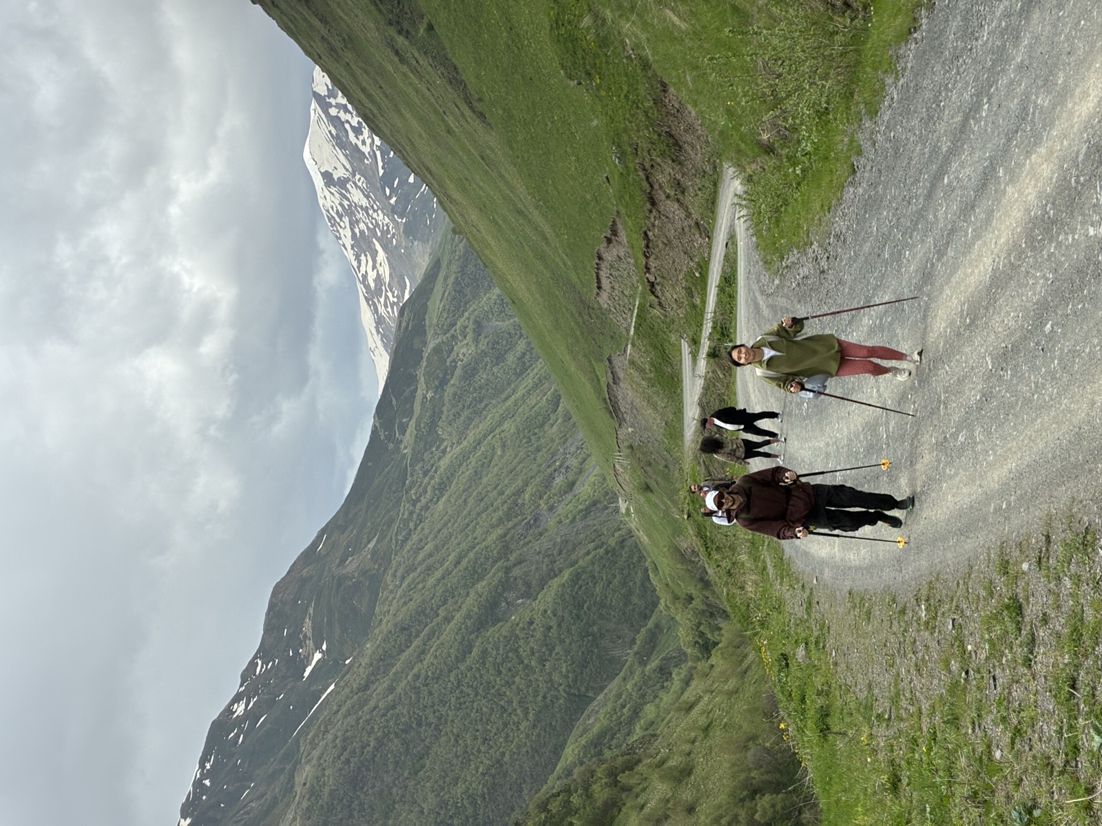 Hikers on a mountain trail in Kazbegi National Park